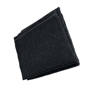Folded black fabric item on a green background