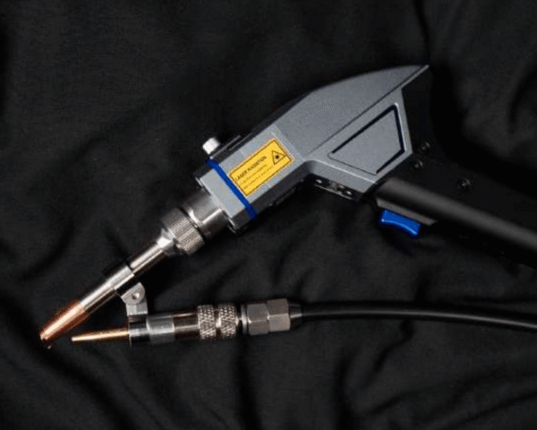 Close-up of a welding tool on black fabric.