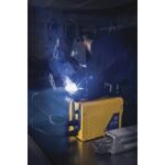 Welding process in a dimly lit workshop.