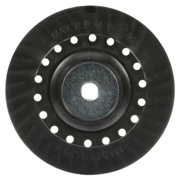 Black circular disc with holes and central hole.