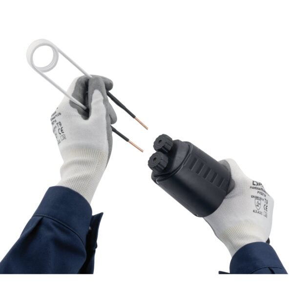 Hands holding wires and electrical component