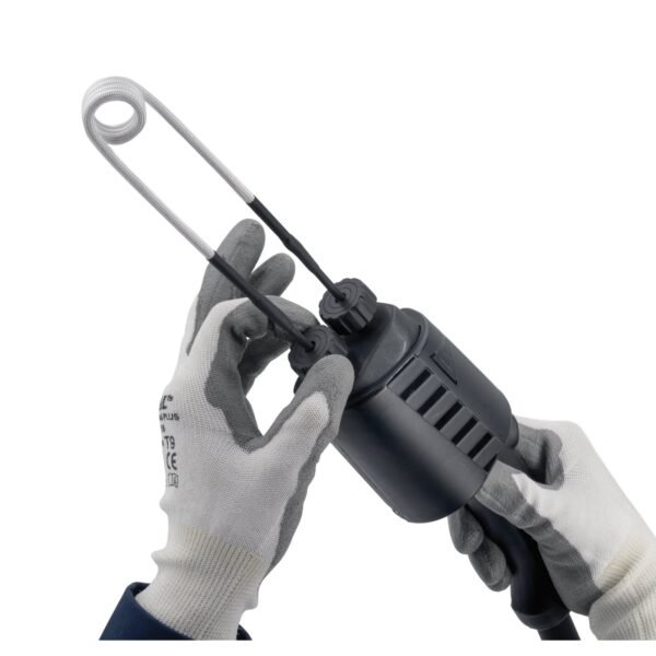 Hands holding a tool with flexible cables.