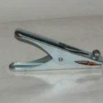 Silver metal stapler on a white surface.