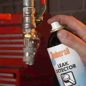 Applying leak detector spray on a fitting
