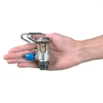 Hand holding a small fire sprinkler head.