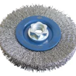 Metal wire cup brush for cleaning surfaces.