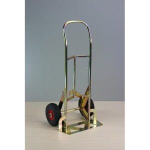 Metal hand truck with red wheels, on a table.