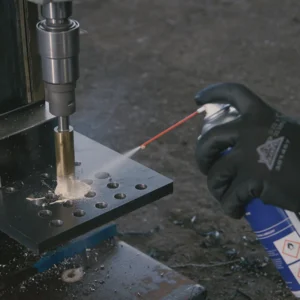 speedlube2_1024x1024.webp Hand using spray lubricator on metal machining tool.