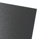Textured dark paper surface with subtle sheen.