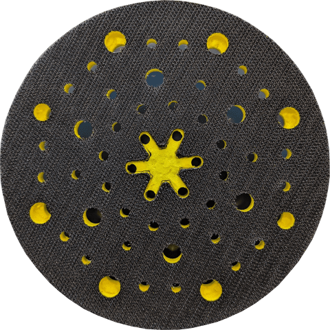 Circular textured surface with holes and yellow accents