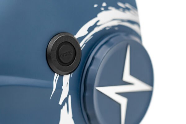 Close-up of a blue device with a grind button.